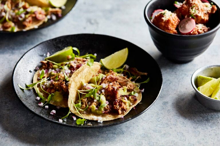 A plate of tacos and side of corn fritters