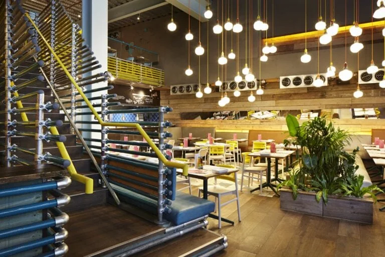 Warmly lit interiors of Wahaca Cardiff with high ceilings
