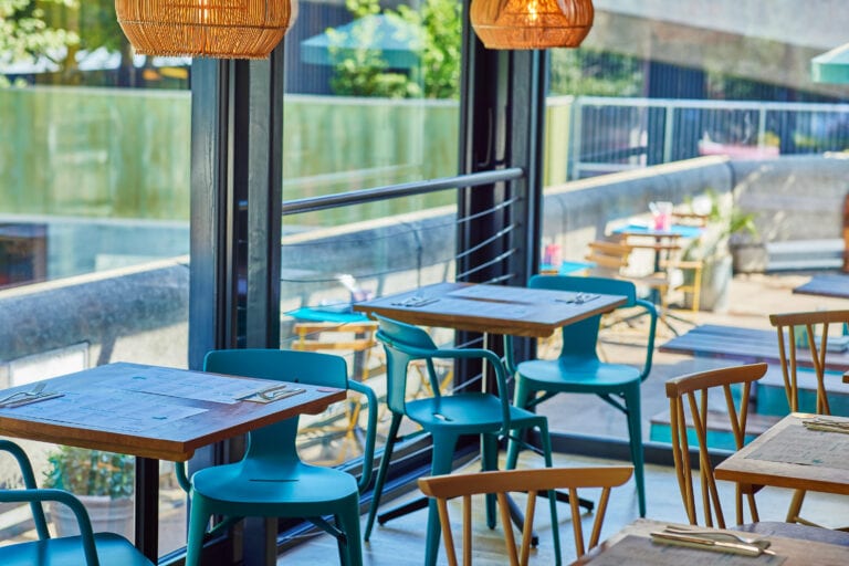 Small tables at Wahaca Southbank overlooking the Southbank