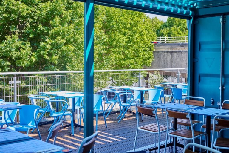 Terrace seating outside upstairs at Wahaca Southbank, with a view over the Southbank and river thames