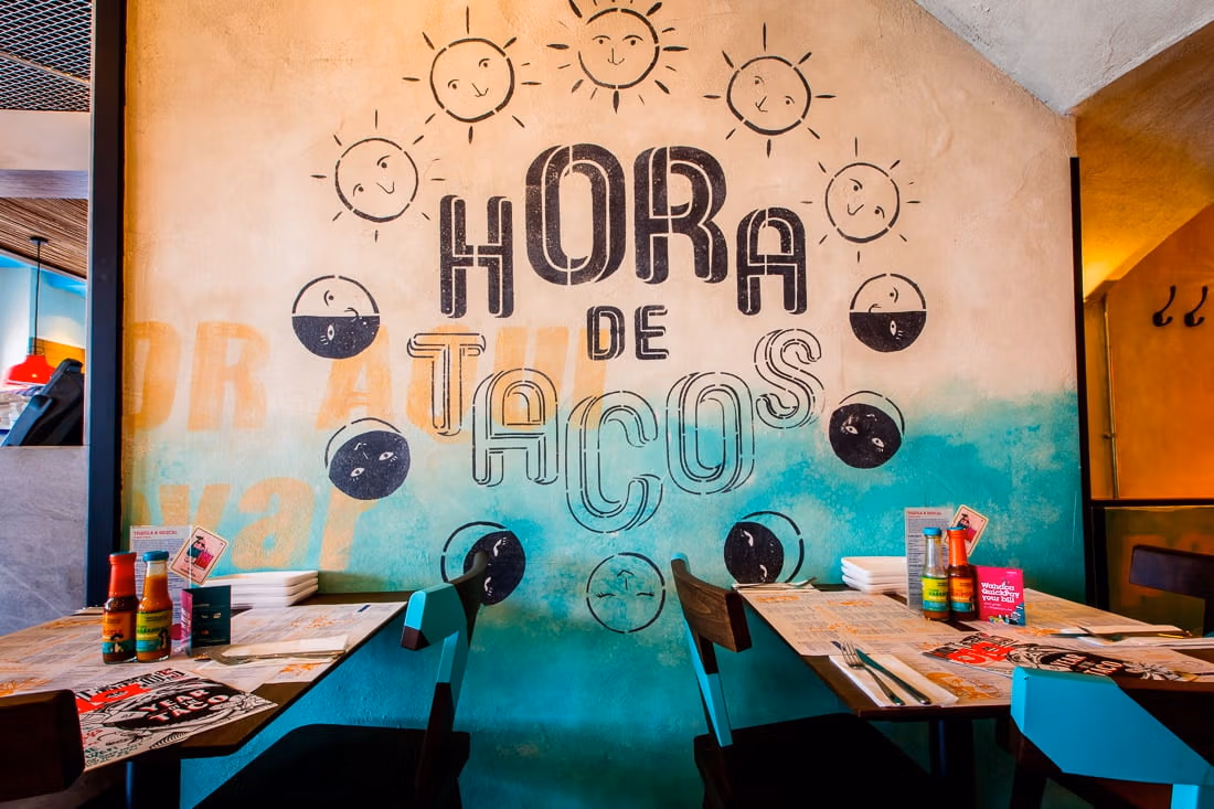 Mural painting saying 'Hora de tacos' on the wall at our Mexican restaurant in Brighton