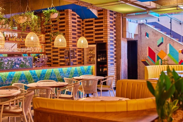 Warm inviting seating at Wahaca Covent garden with large booths and smaller tables