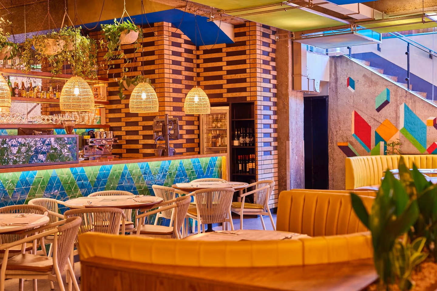 Warm inviting seating at Wahaca Covent garden with large booths and smaller tables