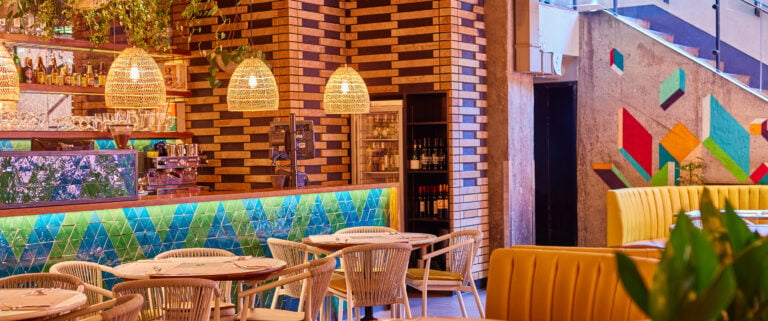 Warm inviting seating at Wahaca Covent garden with large booths and smaller tables