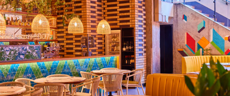 Warm inviting seating at Wahaca Covent garden with large booths and smaller tables