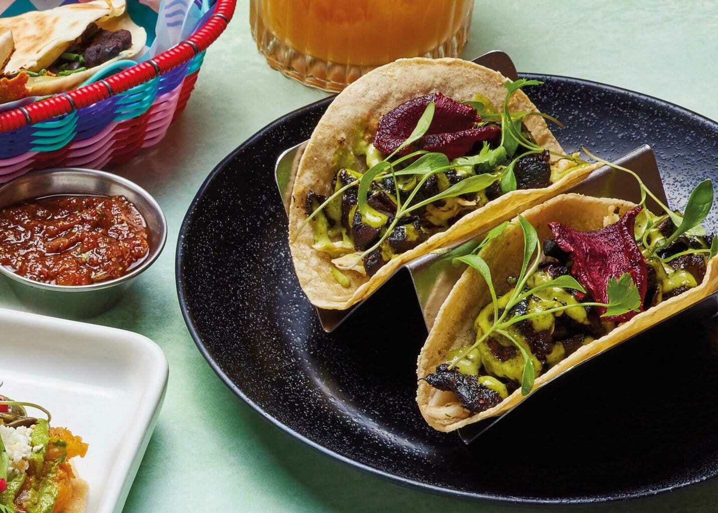 Mushroom tacos topped with beetroot crisps and fresh herbs