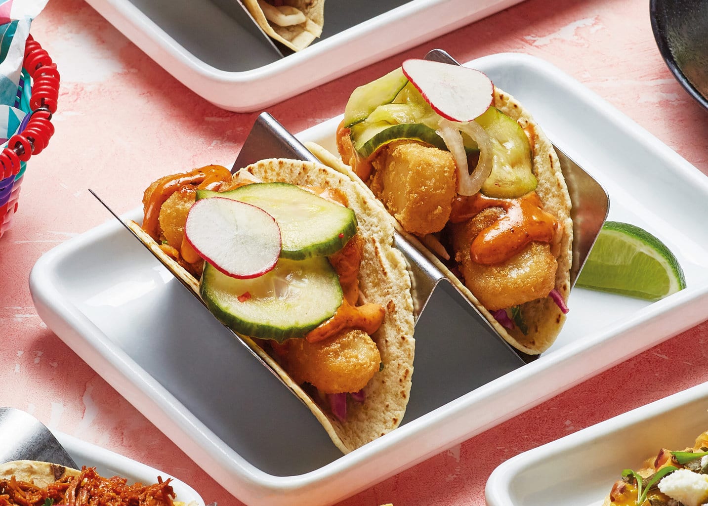 Sustainable fish tacos topped with pickled cucumber