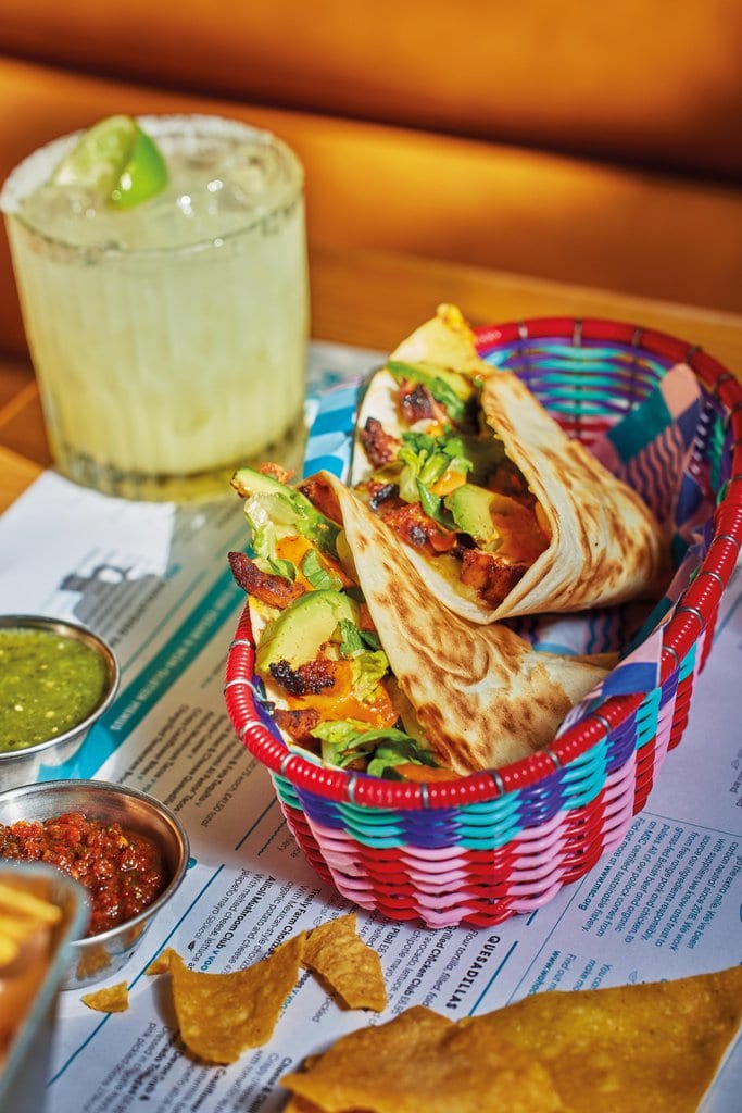 A chicken club quesadilla bursting with juicy chicken, avocado and crunchy lettuce