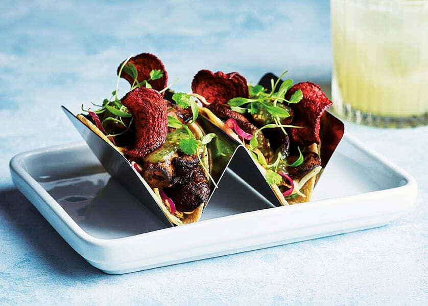 Ancho mushroom tacos topped with beetroot crisps and fresh herbs