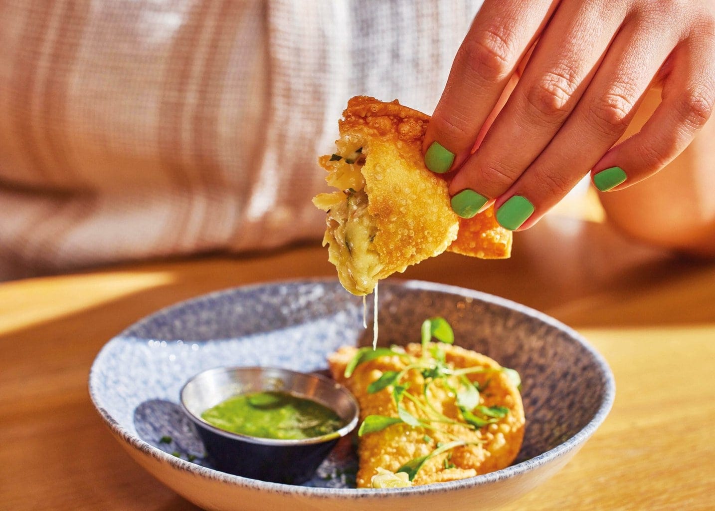 Cheese and jalapeno empanada with cheese oozing from the centre