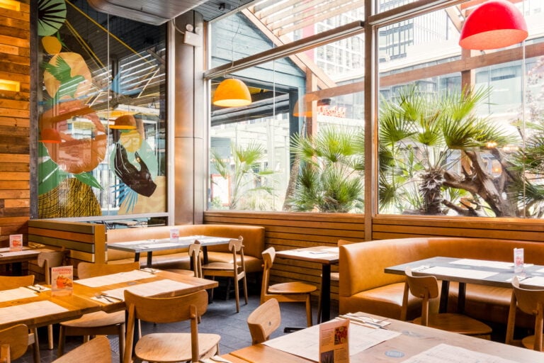 Dining space with natural light from large windows at Wahaca Stratford