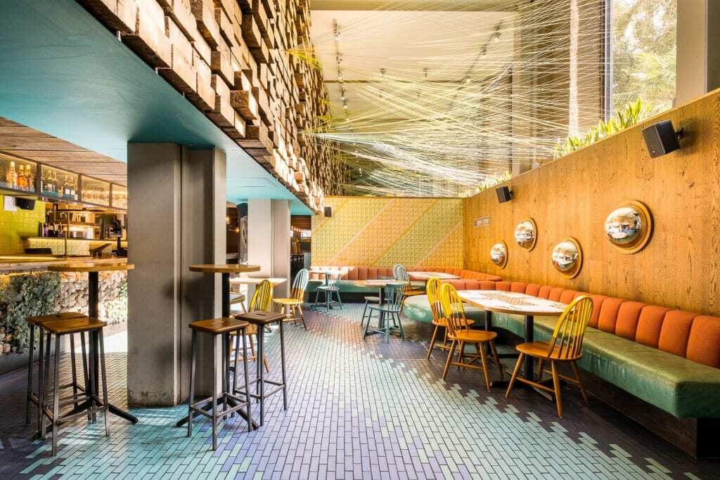 restaurant seating with bar and ceiling decorations at wahaca waterloo
