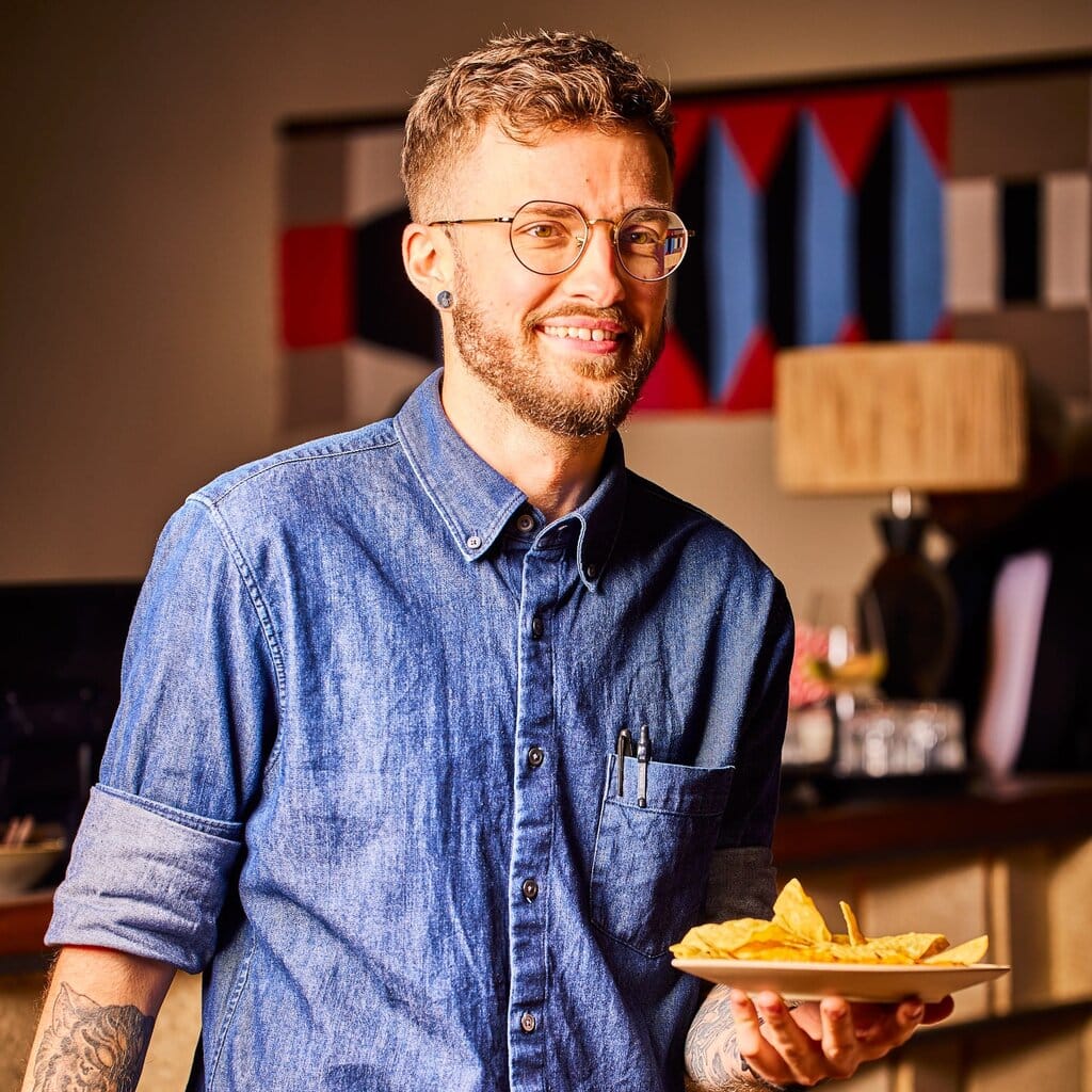 Smiling team member bringing food to table